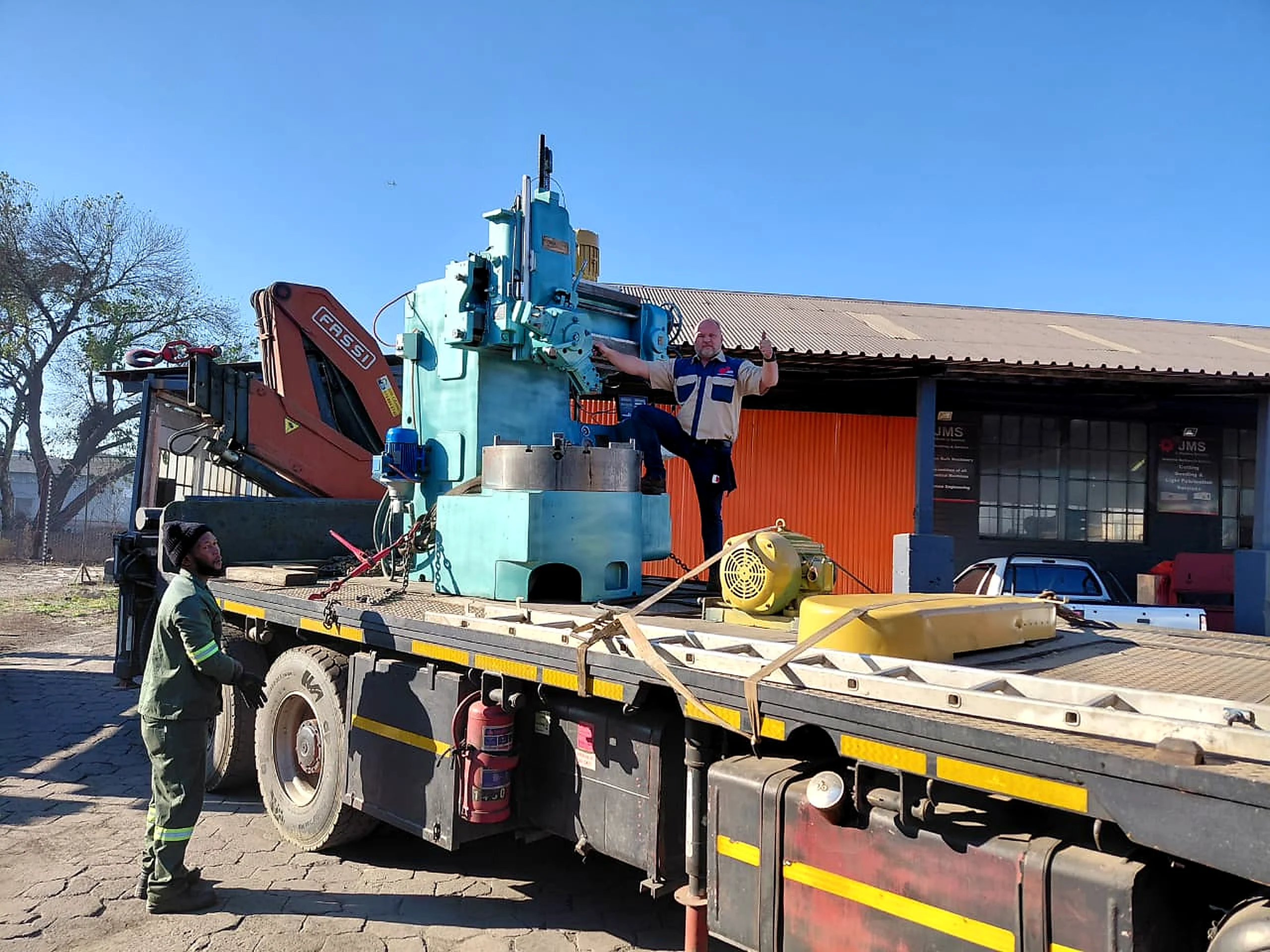 Industrial machine secured on a transport truck